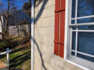 asbestos-cement siding with the characteristic look of "wood grain" shingles